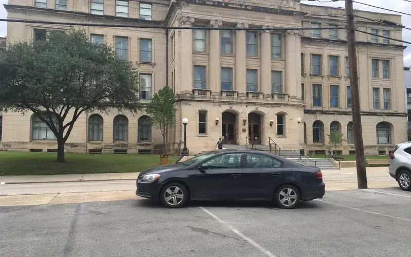 Exterior of a county courthouse building at street level under an overcast sky
