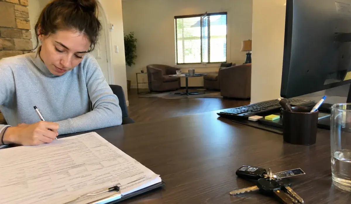 Rental application and paperwork spread out on a leasing office desk