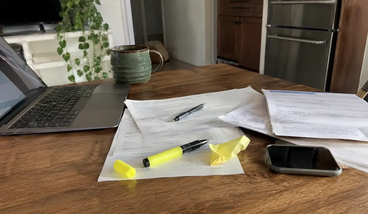 Housing voucher paperwork and a tenancy approval form on a kitchen table